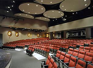 Auditorium space in Coffman Memorial Union featuring seating with plush red upholstery