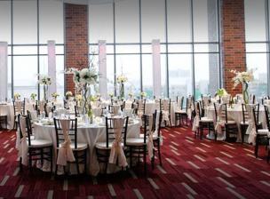 Gopher Sports banquet space with luxurious dining table settings arranged on rich red carpet