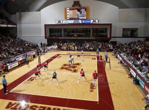 Interior of the Maturi Sports Pavilion - a volleyball game plays on the hardwood court