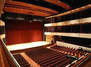 Interior view of Ted Mann Concert Hall from the first balcony - the hardwood stage is backed by rich red curtains