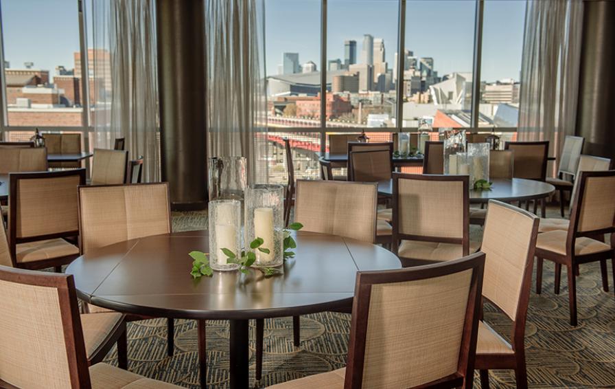View from the Campus Club dining room featuring luxury furnishings and a view of the Minneapolis skyline