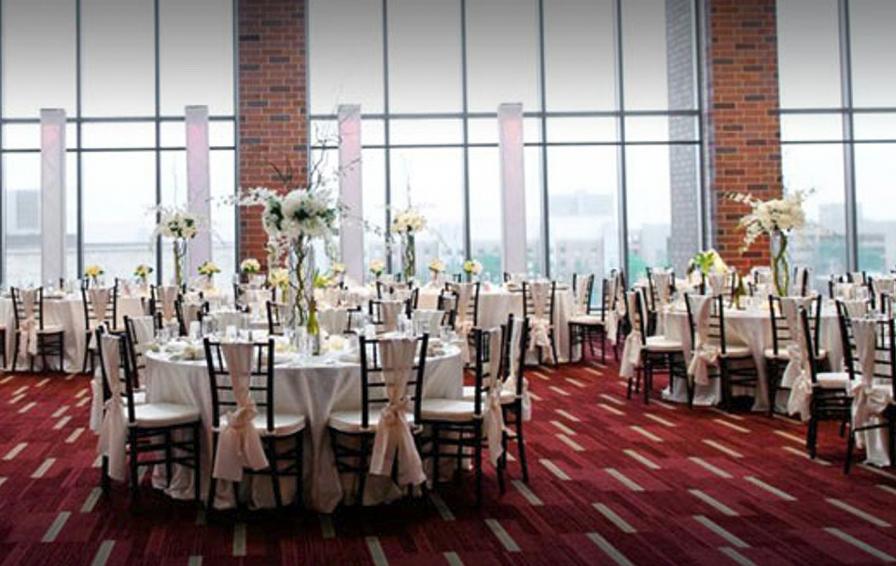 Gopher Sports banquet space with luxurious dining table settings arranged on rich red carpet
